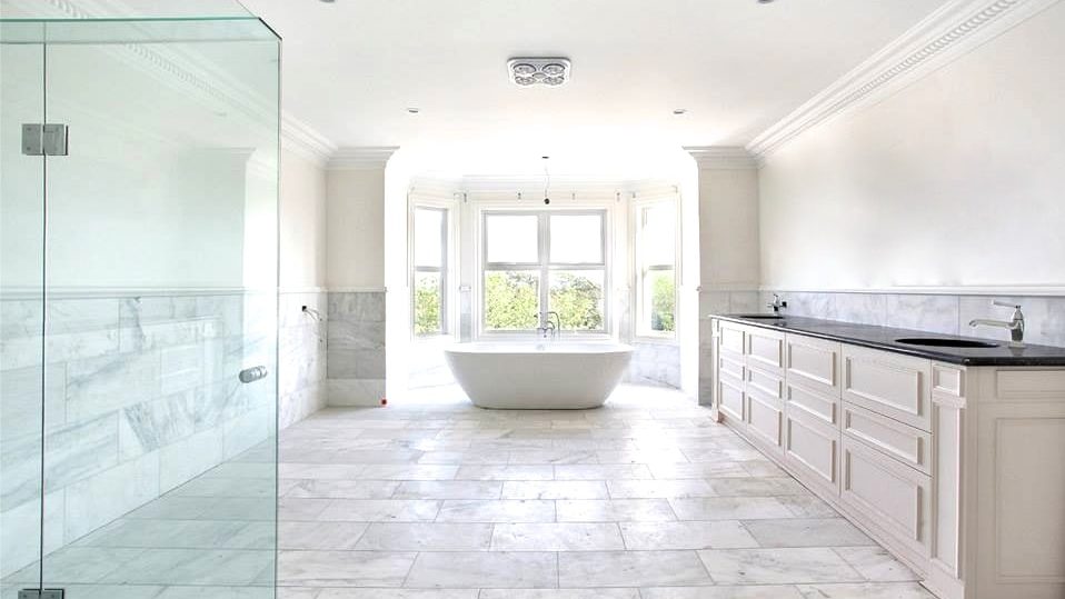 A bathroom with Alabascato marble flooring.