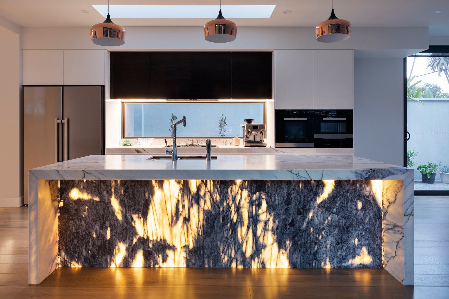 A beautiful modern kitchen with marble benchtops.