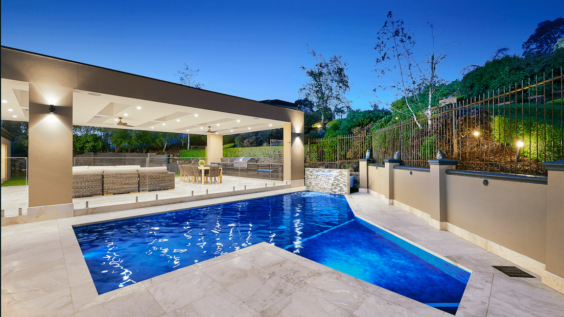 An outdoor pool area with marble tile flooring.